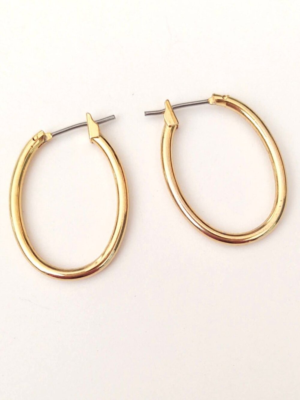 Gold tone oval shaped hoop earrings